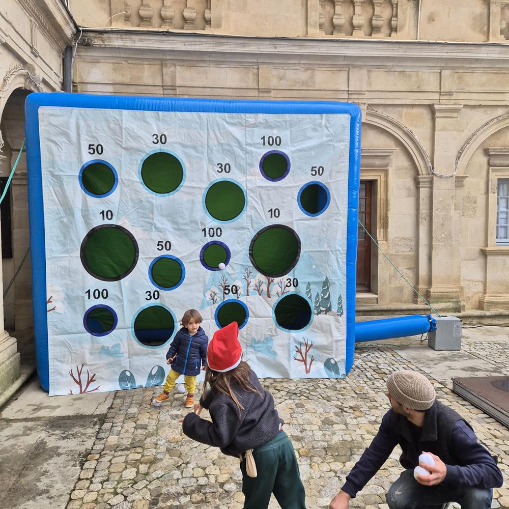 Photo Enfants participant au stand de tir boules de neige lors d'un marché de Noël à Valréas (84)
